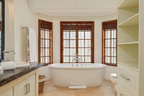 a large bathroom with a tub and a sink at Buccara Wildlife Reserve in Graaff-Reinet