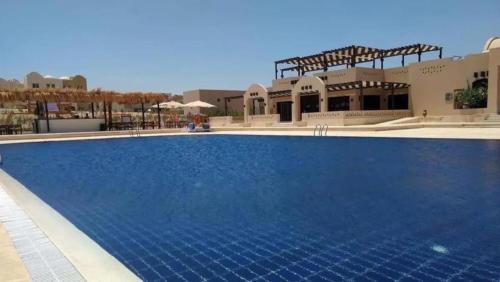 a swimming pool in the middle of a resort at British style in Makadi Heights in Hurghada