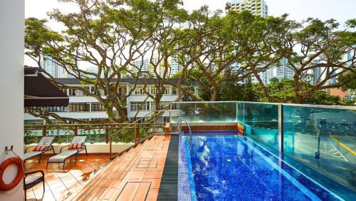 a swimming pool on the roof of a building at Nostalgia Hotel in Singapore