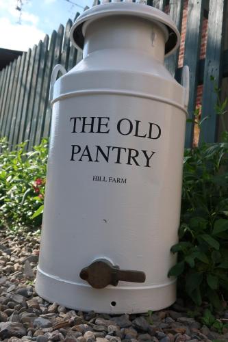 an old paint can sitting on the ground at The Old Pantry at Hill Farm in Penley