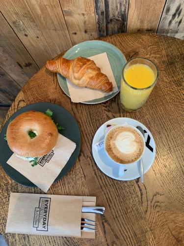 a table with two plates of food and a cup of coffee at In het Assendorpje in Zwolle