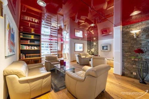 a living room with couches and a table at Turmhotel Victoria Davos in Davos