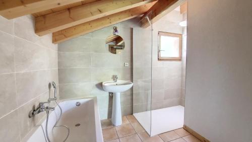 a bathroom with a sink and a toilet and a tub at Chalet MON FRERE in Le Biot