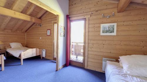 a room with two beds and a window in a cabin at Chalet MON FRERE in Le Biot
