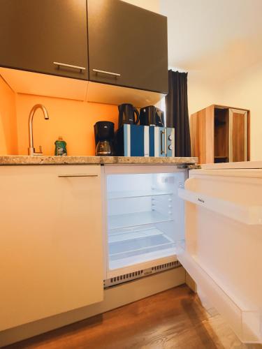 an empty refrigerator in a kitchen with a sink at Intimate Studios Hadersdorf in Hadersdorf am Kamp