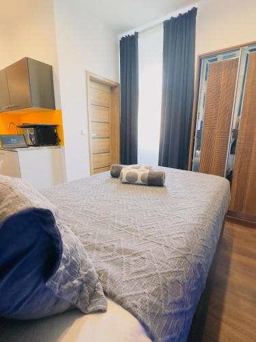 a bedroom with a bed with two pillows on it at Intimate Studios Hadersdorf in Hadersdorf am Kamp