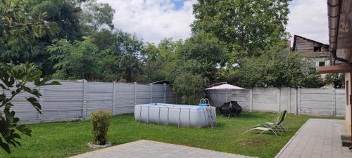 a backyard with a hot tub and a fence at Lovely 1 bedroom flat in a 2 ground floor house in Craiova