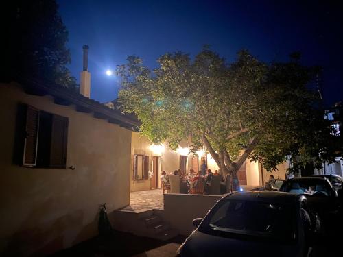 a car parked in front of a house at night at WALNUT TREE VILLA in Archanes
