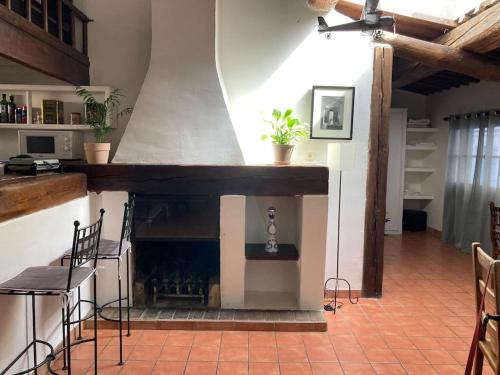 a living room with a fireplace and a table and chairs at Le Cardinale - Un Voyage en Provence in Aix-en-Provence