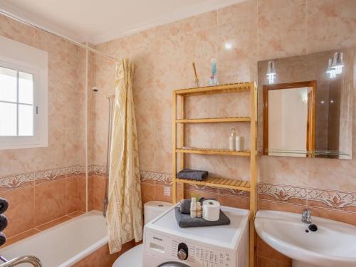 a bathroom with a sink and a washing machine at Terraced Home in Cabo Roig in Cabo Roig