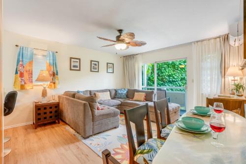 a living room with a table and a couch at Nani Hale in Kapaa