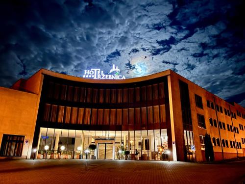 a building with a sign on top of it at Hotel Trzebnica in Trzebnica