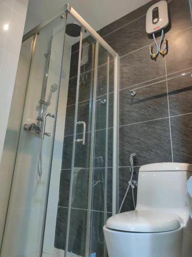 a bathroom with a toilet and a glass shower at 2 Seaview Balcony@Danga Bay in Johor Bahru
