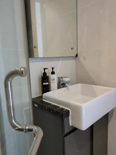 a bathroom with a white sink and a mirror at 2 Seaview Balcony@Danga Bay in Johor Bahru