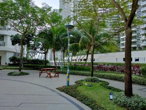 a park with a light pole and a bench and trees at 2 Seaview Balcony@Danga Bay in Johor Bahru