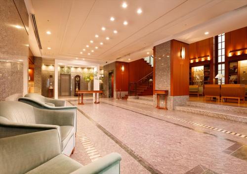a lobby with couches and a table in a building at Kanazawa New Grand Hotel Premier in Kanazawa