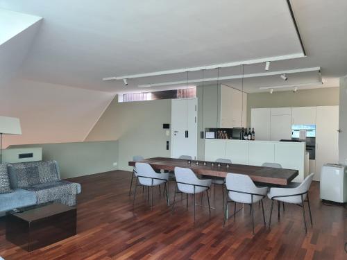 a living room with a dining room table and chairs at Lucerne Lake View Apartments in Luzern