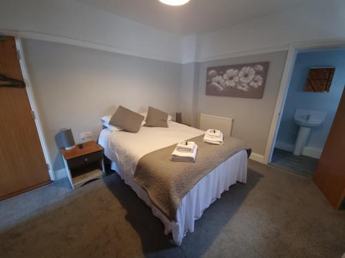 a bedroom with a bed with two towels on it at The Bugle Inn in Southampton