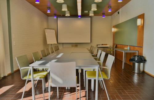 a conference room with a long table and chairs at Saimaanranta Resort by Anttolanhovi in Mikkeli