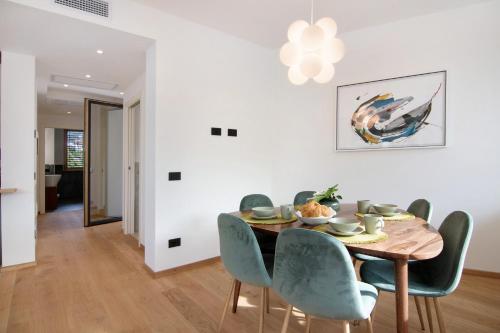 a dining room with a wooden table and chairs at La villa del lago in terrazzo in Colico