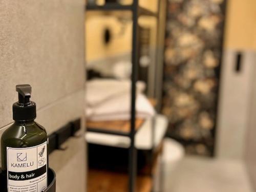 a bottle of alcohol sitting on a counter in a room at ROSER Suiten in Gengenbach