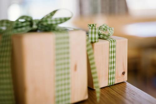 two gift boxes with green bows sitting on a table at Bischoferhaus in Serfaus