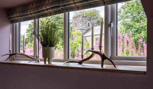 a window sill with two sinks and a potted plant at The Hayloft, Exmoor in Withypool