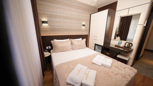 a bedroom with a bed with two towels on it at Bellezza Hotel in Istanbul