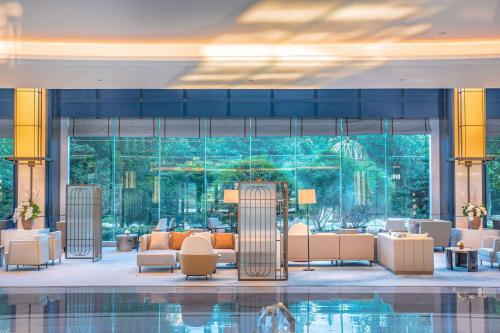 a hotel lobby with a pool in the middle at Wyndham Qingdao in Qingdao