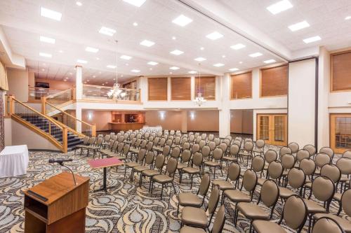 a large room with chairs and a podium in it at Wyndham Garden Madison Fitchburg in Madison