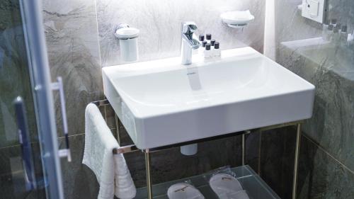 a bathroom with a white sink and a shower at Bellezza Hotel in Istanbul