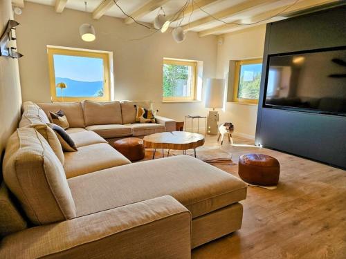 a living room with a couch and a dog in it at Refuge Mil100 in Metzeral