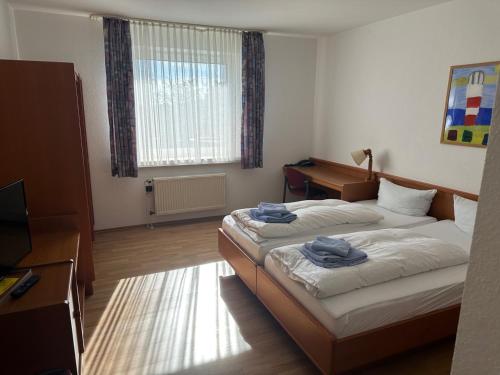 Hotel am Stimbergparkにあるベッド