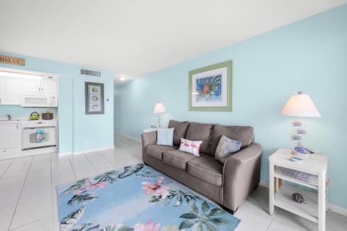 a living room with a couch and a kitchen at Beach Club 403 in Marco Island