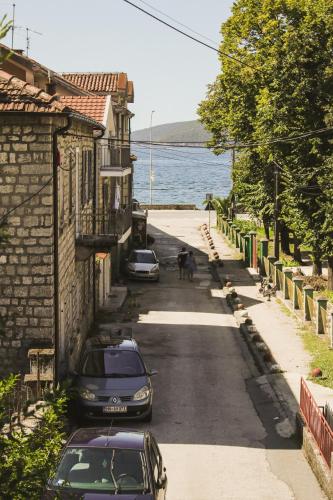 a street with cars parked on the side of the road at SeaView Zelenika in Herceg-Novi