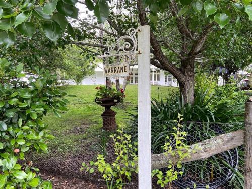 a sign that saysarma in a garden with a plant at Warrane- LUXURY ESTATE WITH POOL & GUESTHOUSE in Long Beach