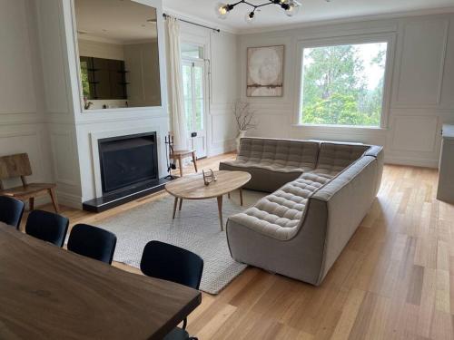 a living room with a couch and a table at Warrane- LUXURY ESTATE WITH POOL & GUESTHOUSE in Long Beach