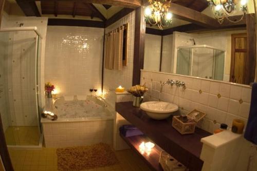 La salle de bains est pourvue d'une baignoire, d'un lavabo et de toilettes. dans l'établissement Pousada Rancho da Ferradura, à Petrópolis