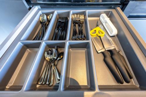 a tray filled with utensils and cutlery at Lielpīles in Radziņciems