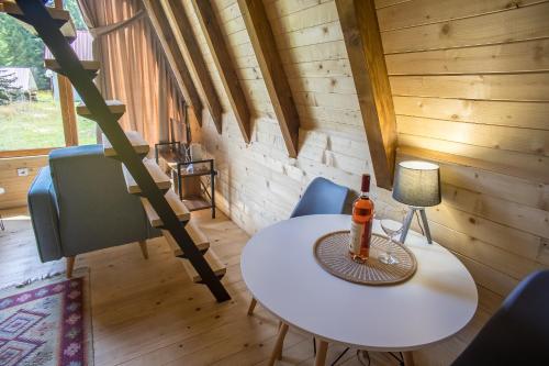 a room with a table and chairs in a cabin at Mountain Houses Emilija in Žabljak