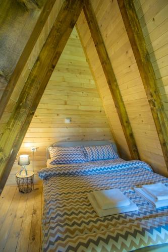 a bedroom with a bed in a attic at Mountain Houses Emilija in Žabljak