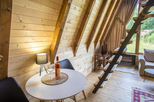 a room with a table and chairs in a cabin at Mountain Houses Emilija in Žabljak