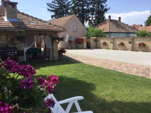 a white bench in the yard of a house at Holiday Home Balatonbereny 2 in Balatonberény