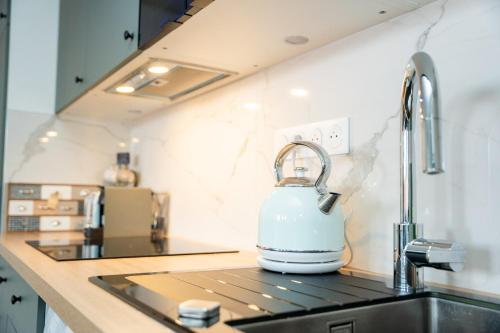 a tea kettle sitting on top of a kitchen sink at 2-Bed Apartment - Sleeps 4 AirCon & Central Links in Le Kremlin-Bicêtre