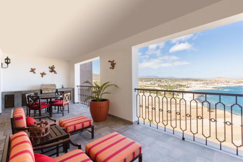 a living room with a balcony with a table and chairs at Vista Encantada in Cabo San Lucas