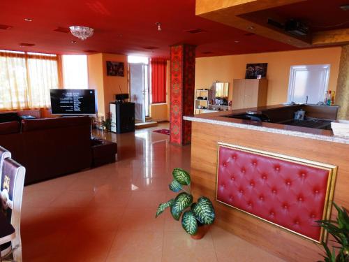 a lobby with a bar and a living room at Apartaments Viktoria in Silistra