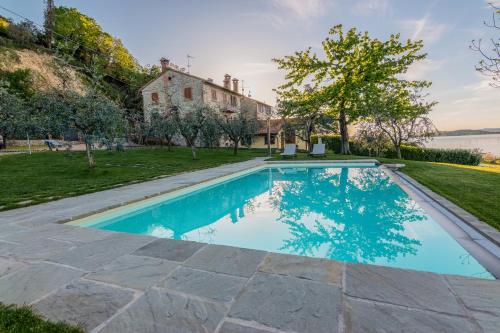 a swimming pool in the backyard of a house at La Folaga del Trasimeno in Magione