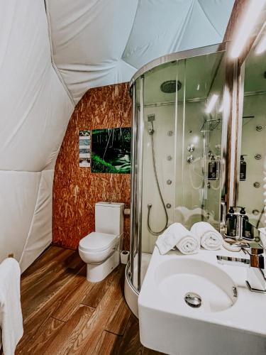 a bathroom with a sink and a toilet in a tent at Natura Glamping in Alcongosta