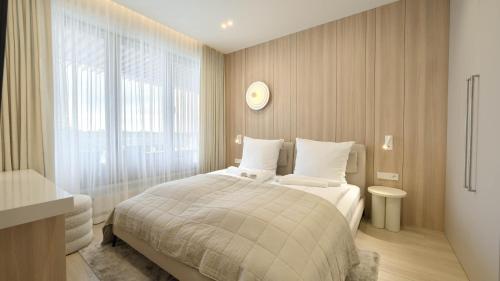a bedroom with a bed and a clock on the wall at Olympic Park I, Sun & Snow in Kołobrzeg