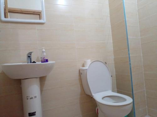 a bathroom with a toilet and a sink at Dar Ziyad Airport in Casablanca